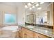 Bathroom with granite vanity, soaking tub, and shower at 1300 Caistor Ln, Raleigh, NC 27614