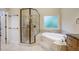 Elegant bathroom with soaking tub, shower, and granite vanity at 1300 Caistor Ln, Raleigh, NC 27614