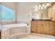 Bathroom with soaking tub, granite countertop, and walk-in shower at 1300 Caistor Ln, Raleigh, NC 27614