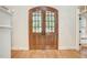 Double wood doors with glass panes in entryway at 1300 Caistor Ln, Raleigh, NC 27614