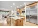 Spacious kitchen with stainless steel appliances, granite countertops, and custom cabinetry at 1300 Caistor Ln, Raleigh, NC 27614