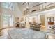 Open living room with high ceilings, hardwood floors, and access to a deck at 1300 Caistor Ln, Raleigh, NC 27614