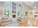 Two-story living room with hardwood floors, fireplace, and abundant natural light at 1300 Caistor Ln, Raleigh, NC 27614