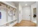 White mudroom with built-in bench, cubbies, and hooks at 1300 Caistor Ln, Raleigh, NC 27614