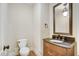 Powder room with dark vanity and mirror at 1300 Caistor Ln, Raleigh, NC 27614