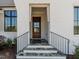 Stone steps leading to a wood front door with black metal railings at 131 Evander Way, Pittsboro, NC 27312