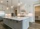 Modern kitchen with white and gray cabinets and a large island at 131 Evander Way, Pittsboro, NC 27312