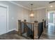 Stunning staircase with wood railing and modern lighting at 131 Evander Way, Pittsboro, NC 27312