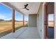 Covered back porch with wood posts and ceiling fan at 137 Glenwood Pl, Kenly, NC 27542