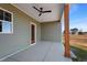 Covered back porch with wood posts and ceiling fan at 137 Glenwood Pl, Kenly, NC 27542