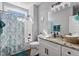 Bathroom with shower/tub combo, granite countertop, and teal accents at 137 Glenwood Pl, Kenly, NC 27542