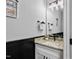 Bathroom with granite countertop, black and white vanity, and decorative mirror at 137 Glenwood Pl, Kenly, NC 27542