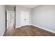 Bedroom with hardwood floors, double door closet, and access to hallway at 137 Glenwood Pl, Kenly, NC 27542