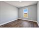 Bright bedroom with wood-look floors and large window at 137 Glenwood Pl, Kenly, NC 27542