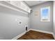 Laundry room with white shelving, rod, and hardwood floors at 137 Glenwood Pl, Kenly, NC 27542