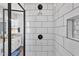 Clean shower with white subway tile and black accents at 137 Glenwood Pl, Kenly, NC 27542