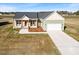 Aerial view of a charming single-Gathering home with a two-car garage and landscaped yard at 137 Glenwood Pl, Kenly, NC 27542