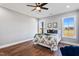 Spacious bedroom with hardwood floors, natural light, and a ceiling fan at 137 Glenwood Pl, Kenly, NC 27542