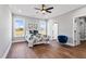 Bedroom with hardwood floors, two windows, ceiling fan, and a walk-in closet at 137 Glenwood Pl, Kenly, NC 27542
