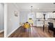 Bright dining area with wood floors, a view to the yard, and modern chandelier lighting at 137 Glenwood Pl, Kenly, NC 27542