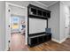 Stylish entryway with built-in shelving and seating, leading into a bright bedroom at 137 Glenwood Pl, Kenly, NC 27542