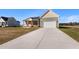 Long driveway leading up to a house with a two-car garage and charming covered porch at 137 Glenwood Pl, Kenly, NC 27542