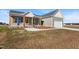 Well-manicured front lawn with colorful landscaping leading up to a house with a covered porch at 137 Glenwood Pl, Kenly, NC 27542