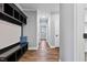 Hallway featuring wood flooring, gray walls, coat rack, and white trim and doors at 137 Glenwood Pl, Kenly, NC 27542