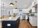 Modern kitchen featuring a large center island with pendant lights, white cabinetry, and stainless steel appliances at 137 Glenwood Pl, Kenly, NC 27542