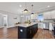 Well-lit kitchen featuring a central island with granite countertops and stainless steel appliances at 137 Glenwood Pl, Kenly, NC 27542
