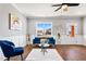 Bright living room features a blue velvet couch, decorative accents and stylish furnishings at 137 Glenwood Pl, Kenly, NC 27542