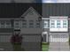 Two-story townhome with gray siding, white accents, and a two-car garage at 174 Nimble Way # 222, Clayton, NC 27520