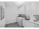 Bright laundry room with modern washer, dryer, and ample cabinetry at 1820 Park Dr, Raleigh, NC 27605