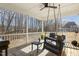 Inviting back porch with a swing, ceiling fan, and relaxing outdoor living space at 221 Old Hickory Dr, Raleigh, NC 27603