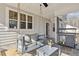 Charming back porch with a swing, outdoor dining area, and relaxing entertainment space at 221 Old Hickory Dr, Raleigh, NC 27603