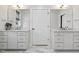 Bathroom featuring a dual sink vanity with marble floors and large mirrors at 221 Old Hickory Dr, Raleigh, NC 27603