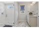 Bright bathroom with a glass shower, modern vanity, and natural light from a window at 221 Old Hickory Dr, Raleigh, NC 27603