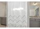 Bathroom featuring neutral vanity, sink, mirror and a decorative white shower curtain at 221 Old Hickory Dr, Raleigh, NC 27603