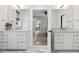 Bathroom featuring dual vanities with marble floors and a view to the kitchen at 221 Old Hickory Dr, Raleigh, NC 27603