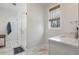 Bright bathroom with a glass shower, marble floors, and a single vanity at 221 Old Hickory Dr, Raleigh, NC 27603