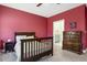 Bedroom with neutral carpet, wood-frame bed, a dresser, and an en-suite bathroom at 221 Old Hickory Dr, Raleigh, NC 27603