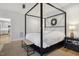 Bedroom with a four-poster bed, white linens, and dark-wood bedside tables at 221 Old Hickory Dr, Raleigh, NC 27603