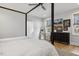 Modern bedroom featuring a four-poster bed and view to the outdoors at 221 Old Hickory Dr, Raleigh, NC 27603