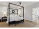 This bedroom boasts a four poster bed, a modern ceiling fan and neutral decor at 221 Old Hickory Dr, Raleigh, NC 27603