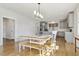 Bright dining area adjacent to kitchen features a large table and stylish pendant lighting at 221 Old Hickory Dr, Raleigh, NC 27603