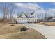 Spacious two-story home with a large driveway, two-car garage, and a welcoming front porch at 221 Old Hickory Dr, Raleigh, NC 27603