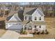 Charming two-story home with a brick-accented porch, well-maintained landscaping, and an attached two-car garage at 221 Old Hickory Dr, Raleigh, NC 27603