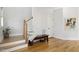 Bright foyer with hardwood floors, a staircase, and a decorative wooden bench at 221 Old Hickory Dr, Raleigh, NC 27603