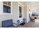 Cozy front porch with chairs, brick flooring, and an elegant front door at 221 Old Hickory Dr, Raleigh, NC 27603
