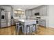 Bright kitchen with stainless steel appliances, gray cabinets, large island and breakfast bar at 221 Old Hickory Dr, Raleigh, NC 27603